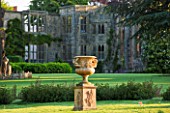 NYMANS  SUSSEX. THE NATIONAL TRUST: URN ON LAWN WITH HOUSE BEHIND  MORNING LIGHT  JUNE