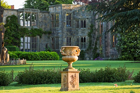 NYMANS__SUSSEX_THE_NATIONAL_TRUST_URN_ON_LAWN_WITH_HOUSE_BEHIND__MORNING_LIGHT__JUNE