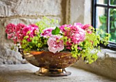 CONTAINER IN STONE WINDOW - DESIGN BY JACKY HOBBS - METAL CONTAINER WITH FRECHLY PICKED FLOWERS - ROSES  ALCHEMILLA MOLLIS AND CENTRANTHUS RUBER