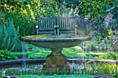 OLD THATCH  BERKSHIRE: THE WATER GARDEN - FOUNTAIN WITH BENCH BEHIND