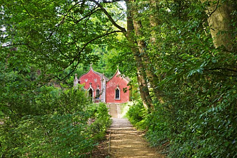 PAINSWICK_ROCOCO_GARDEN__GLOUCESTERSHIRE_THE_RED_HOUSE_SEEN_ALONG_A_WOODLAND_PATH