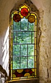 PAINSWICK ROCOCO GARDEN  GLOUCESTERSHIRE: STAINED GLASS IN A WINDOW IN THE RED HOUSE