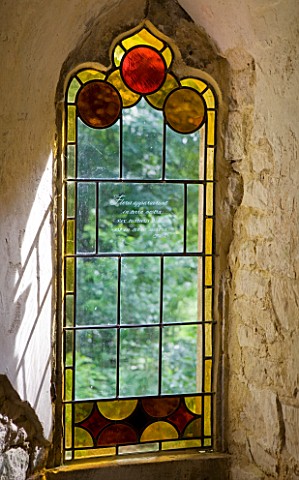 PAINSWICK_ROCOCO_GARDEN__GLOUCESTERSHIRE_STAINED_GLASS_IN_A_WINDOW_IN_THE_RED_HOUSE