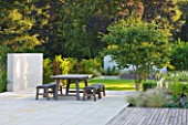 DEW POND HOUSE: DESIGN BY WILSON MCWILLIAM STUDIO - MAIN TERRACE/PATIO - TABLE AND CHAIRS  AMELANCHIER LAMARCKII  IPE DECKING  PALE SANDSTONE PAVING