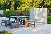 DEW POND HOUSE: DESIGN BY WILSON MCWILLIAM STUDIO - MAIN TERRACE/PATIO - TABLE & CHAIRS  PALE SANDSTONE PAVING AND RENDERED WALL
