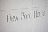 DEW POND HOUSE: DESIGN BY WILSON MCWILLIAM STUDIO - DEW POND HOUSE NAME CARVED INTO HOUSE WALL