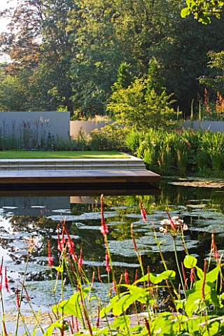 DEW_POND_HOUSE_DESIGN_BY_WILSON_MCWILLIAM_STUDIO__VIEW_ACROSS_MAIN_POND_TO_TERRACE__DECK_AND_RENDERE