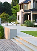 DEW POND HOUSE: DESIGN BY WILSON MCWILLIAM STUDIO - REAR TERRACE/ PATIO WITH IPE DECK  STEPS  LIMESTONE PAVING  LAWN  DECK CHAIRS