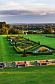 THE NATIONAL TRUST: CLIVEDEN  BUCKINGHAMSHIRE: THE PARTERRE IN EVENING LIGHT WITH GLADIOLI AND VIEWS TO THE COUNTRYSIDE BEYOND. AUGUST