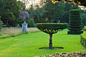 THE NATIONAL TRUST: CLIVEDEN  BUCKINGHAMSHIRE: TOPIARY AND URNS IN THE LONG GARDEN  EVENING LIGHT