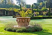 HEVER CASTLE  KENT: AUTUMN: LARGE TERRACOTTA CONTAINER ON LAWN IN ITALIAN GARDENS