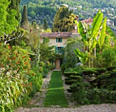 VILLA FORT FRANCE  GRASSE  FRANCE: THE FRONT GARDEN WITH VIEW TO VILLA  PATH  CLOUD TOPIARY AND BANANAS