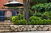 LA CASELLA, FRANCE: STEPS TO FRONT OF HOUSE WITH ROCKS, BOX BALLS, TERRACE, FOUNTAIN, WALL, MEDITERRANEAN, BUXUS, PATIO, GREEN, FOLIAGE, SPHERES, FORMAL