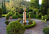LA CASELLA, FRANCE: PATIO / TERRACE WITH COBBLES, BOX BALLS IN CONTAINERS, BOX EDGED FOUNTAIN / POOL / POND, FASTIGIATE CYPRESS TREES. PATIO, MEDITERRANEAN, FRENCH, FORMAL, GREEN