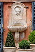 A CASELLA, FRANCE: STONE FOUNTAIN, CLIPPED, TOPIARY, MEDITERRANEAN, FRENCH, FORMAL, EVERGREENS, SUMMER, PROVENCE, BOX, BUXUS