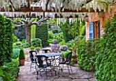 LA CASELLA, FRANCE: TERRACE, PATIO, TABLE, CHAIRS, PERGOLA, WISTERIA, WHITE, COVERED, ENTERTAINING, DINING, MEDITERRANEAN, PROVENCE, FRENCH