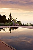 DESIGNER JAMES BASSON, SCAPE DESIGN, FRANCE: SKY REFLECTED IN SWIMMING POOL - WATER, REFLECTION, REFLECTIONS, DAWN,FIRST LIGHT, DECKCHAIR, DECK CHAIR