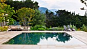 DESIGNER JAMES BASSON, SCAPE DESIGN, FRANCE: SWIMMING POOL WITH LAGERSTROEMERIA INDICA TREE - PROVENCE, SUMMER
