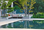 DESIGNER JAMES BASSON, SCAPE DESIGN, FRANCE: SWIMMING POOL WITH REFLECTION OF LAGERSTROEMERIA INDICA TREE - PROVENCE, SUMMER, REFLECTIONS, SEATING, CUSHIONS, TERRACE, PATIO