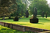 DODDINGTON PLACE GARDENS  KENT: TOPIARY ON THE LAWN BESIDE THE HOUSE