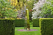 DODDINGTON PLACE GARDENS  KENT: BLOSSOM IN THE SPRING GARDEN WITH MIRRORED OBELISK BY DAVID HARBOUR