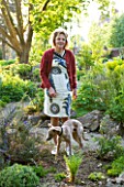 DODDINGTON PLACE GARDENS  KENT: GARDEN OWNER AMICIA OLDFIELD WITH HER PET DOG - WHIPPET BISCOE