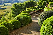 LA CARMEJANE, FRANCE: LUBERON, PROVENCE, FRENCH, COUNTRY, GARDEN, SUMMER, CLIPPED, TOPIARY, BALLS, HEDGING, TERRACE, TABLE, CHAIRS, VIEW, COUNTRYSIDE, BORROWED, LANDSCAPE