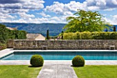 GARDEN IN LUBERON  FRANCE  DESIGNED BY MICHEL SEMINI: LAWN AND PATH TO SWIMMING POOL WITH LUBERON HILLS BEHIND - WASSERMAN GARDEN