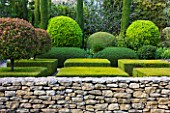 GARDEN IN LUBERON  FRANCE  DESIGNED BY MICHEL SEMINI: STONE WALL  CLIPPED TOPIARY AND CYPRESS TREES IN A FORMAL GARDEN - WASSERMAN GARDEN