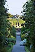 TRESCO ABBEY GARDEN  TRESCO   ISLES OF SCILLY: VIEW DOWN THE NEPTUNE STEPS TO SCULPTURE - TRESCO CHILDREN BY DAVID WYNNE