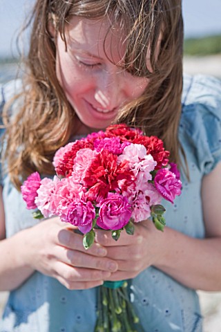 THE_ISLES_OF_SCILLY_SCILLY_FLOWERS__FRESHLY_PICKED_SCENTED_PINKS_BY_THE_SEA__HELD_BY_STEPH_HILL