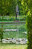 GLYNDEBOURNE, EAST SUSSEX: VIEW ACROSS LAKE TO BRONZE FIGURE OF A DIVER - WATER, POOL, TRANQUIL, PEACEFUL, COUNTRY GARDEN, LANDSCAPE. SCULPTURE, ORNAMENT