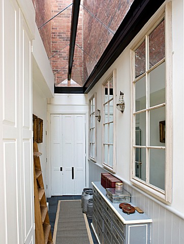 RICHARD_CARNILL_HOUSE__NOTTINGHAMSHIRE_NARROW_GLASS_ROOFED_SIDE_ENTRANCE_WITH_MIRRORS__FORMER_SEED_C