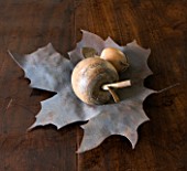 RICHARD CARNILL HOUSE  NOTTINGHAMSHIRE: RUSTY METAL LEAF BOWL FROM THE POTTING SHED  ALDERLY EDGE - WOOD AND METAL FRUIT MADE FROM OLD FRENCH FISHING FLOATS