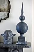 RICHARD CARNILL HOUSE  NOTTINGHAMSHIRE: LEAD FINIAL  DECORATIVE SHEEPS HEAD AND ANTIQUE VENITIAN MIRROR ON MANTELPIECE IN LIVING ROOM