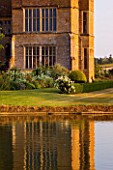 BROUGHTON CASTLE, OXFORDSHIRE: VIEW OF CASTLE ACROSS LAKE WITH REFLECTIONS - REFLECTION, COUNTRY GARDEN, CLASSIC, SUMMER, REFLECTED