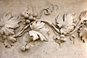 KILLERTON, DEVON: THE NATIONAL TRUST: DETAIL OF GRAPES AND VINE LEAVES ON COADE STONE URN, CONTAINER. ORNAMENT