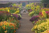 HELMSLEY WALLED GARDEN  YORKSHIRE: THE HERBACEOUS BORDER IN JULY DOMINATED BY VERBASCUMS  MONARDAS  CROCOSMIA  GALLARDIAS AND ANTHEMIS