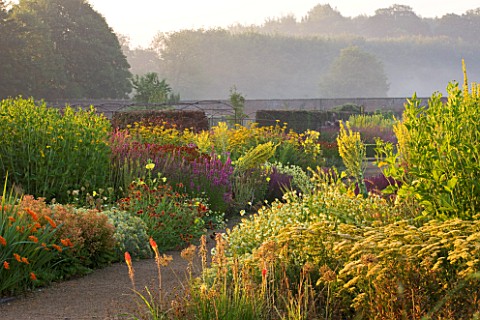 HELMSLEY_WALLED_GARDEN__YORKSHIRE_THE_HERBACEOUS_BORDER_IN_JULY_DOMINATED_BY_VERBASCUMS__MONARDAS__C