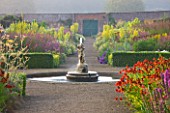 HELMSLEY WALLED GARDEN  YORKSHIRE: THE HERBACEOUS BORDER IN JULY WITH FOUNTAIN  HELENIUMS AND VERBASCUMS