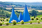 YORKSHIRE LAVENDER  YORKSHIRE:LAVENDER - BLUE MULTI PYRAMIDAL SCULPTURE WHICH IS A MEMORIAL TO LYNNE GOODWILL  SURROUNDED BY STIPA TENUISSIMA WITH VIEWS TO THE HILLS BEYOND