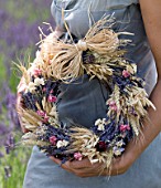 YORKSHIRE LAVENDER  YORKSHIRE:GIRL HOLDING DECORATIVE LAVENDER WREATHS MADE FROM DRIED LAVENDER