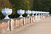 CHATEAU DE CHENONCEAU  FRANCE: HUGE WHITE URNS ALONG A WALL IN DIANES GARDEN