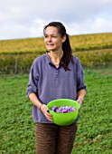 DOMINIQUE BLANCHARD SAFFRON FARM  LOIRE VALLEY FRANCE: DOMINIQUE HOLDING A BASKET OF FRESHLY PICKED CROCUS SATIVUS