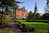 WELFORD PARK, BERKSHIRE: THE HOUSE AND CHURCH IN WINTER - FEBRUARY, LAWN, COUNTRY GARDEN
