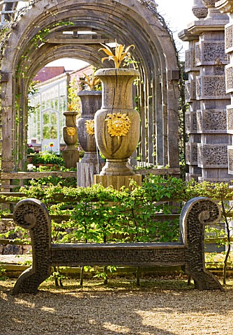 ARUNDEL_CASTLE_GARDENS__WEST_SUSSEX_THE_COLLECTOR_EARLS_GARDEN_CARVED_OAK_URNS_WITH_GILDED_LIONS_HEA