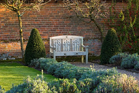 COUGHTON_COURT__WARWICKSHIRE_WHITE_PAINTED_BENCH_AT_THE_END_OF_THE_LONG_PATHWAY_BORDER_PLANTED_WITH_