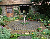 OCTAGONAL COURTYARD GARDEN WITH BRICK PAVING  CONTAINERS AND BIRDBATH IN FRONT OF OLD COACH HOUSE. TURN END  BUCKS.