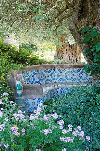 SICILY__ITALY_SAN_GIULIANO_ESTATE_A_MORROCAN_INFLUENCED_TILED_SEATING_AREA_IN_THE_ARABIC_GARDEN_WITH