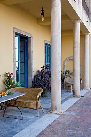 SICILY__ITALY_CASA_CUSENI_IN_TAORMINA__TERRACOTTA_AND_MARBLE_TILED_TERRACE__PATIO_WITH_WRATTEN_SEAT_